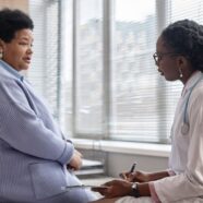 An African American endocrinologist reviews CGM data with her diabetic patient.